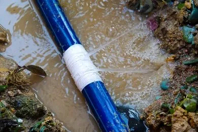 Burst underground water pipe leaking water at a residential property in Emerald, Queensland.
