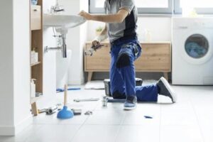 Professional plumber repairing a bathroom sink as part of residential plumbing services in Emerald, Queensland. Nash Plumbing & Civil provides reliable plumbing repairs, maintenance, installations, leak detection, blocked drains, hot water services, and emergency plumbing for homes.